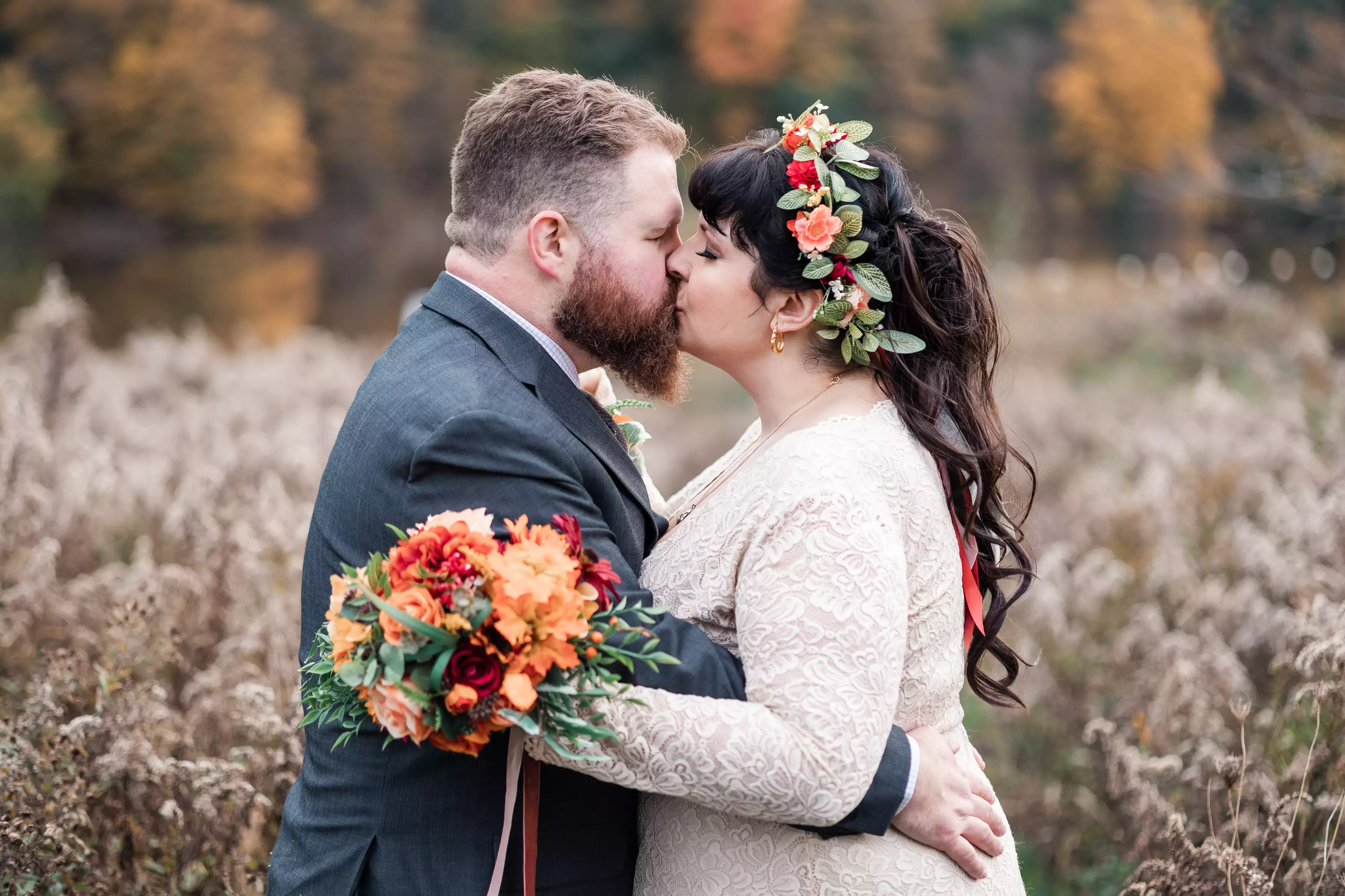 Wedding couple embracing in a field during golden hour at Christie Lake In Hamilton Ontario.